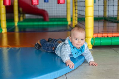 A happy baby laying down in play area