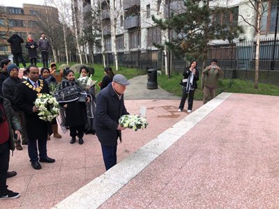 Mayor John Biggs lays a wreath