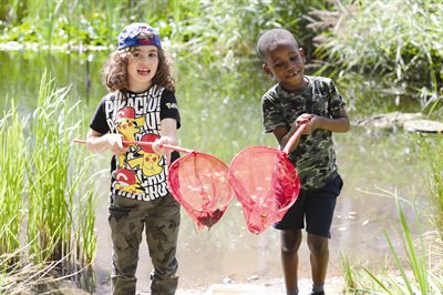 Kids show what they have caught at the Ecology