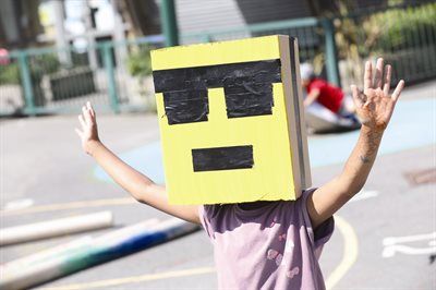 Kid with cardboard box on their head