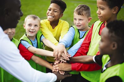 Kids huddling before a football game
