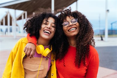 Two happy teenage girls smiling
