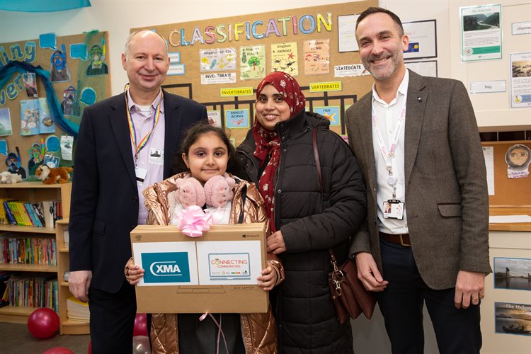 Akifa Karim, Year 3, with mum, receiving laptop