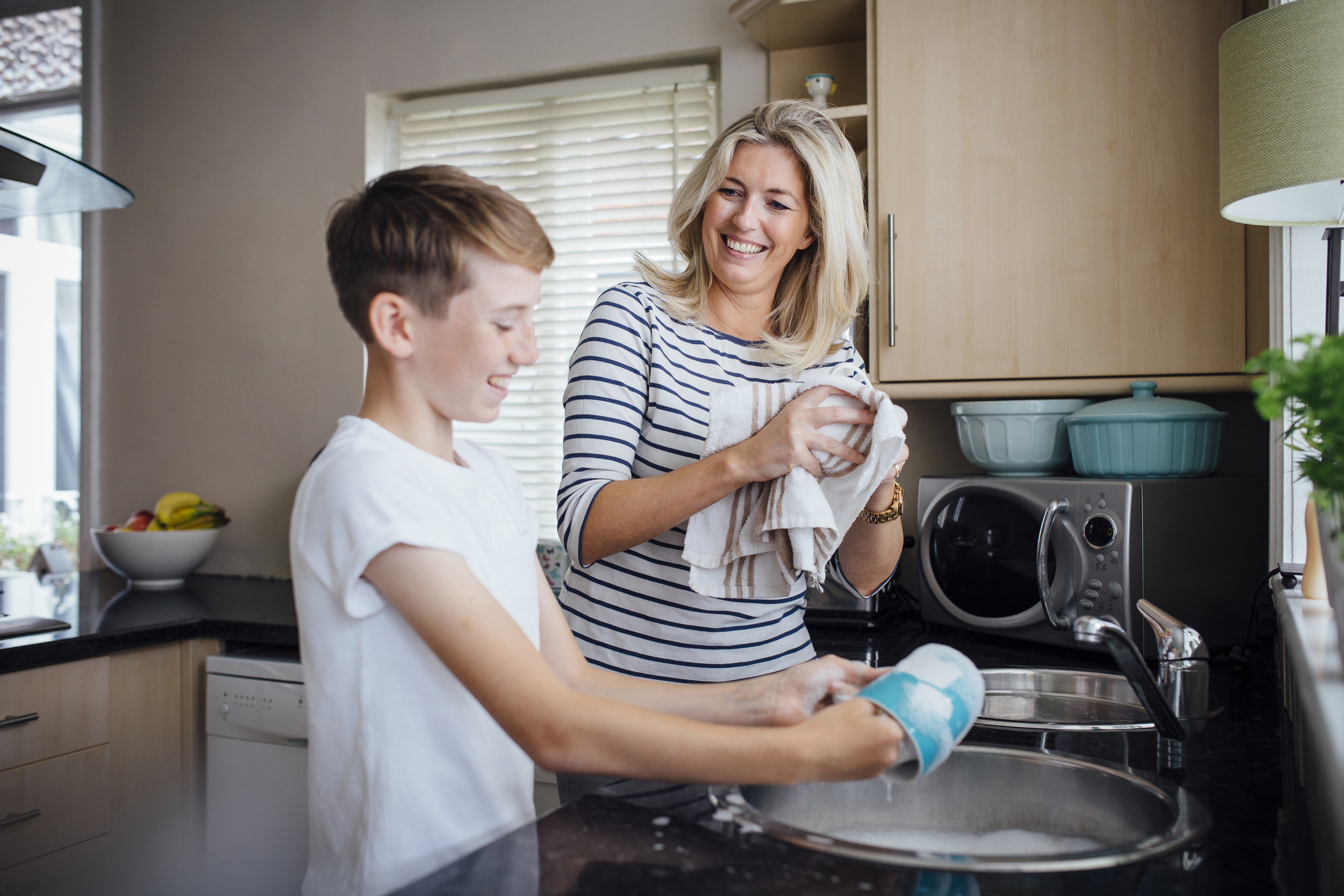 Mum and young person washing up