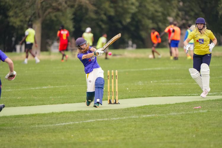 Player hitting cricket ball