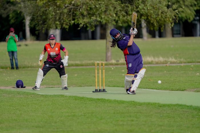 Whacking cricket ball