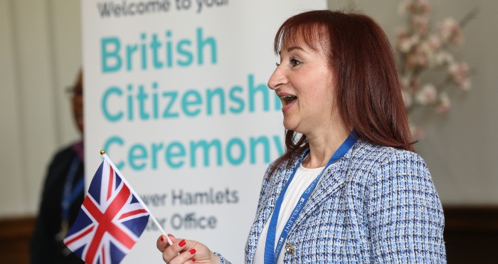 Lady with flag at a citizenship ceremony